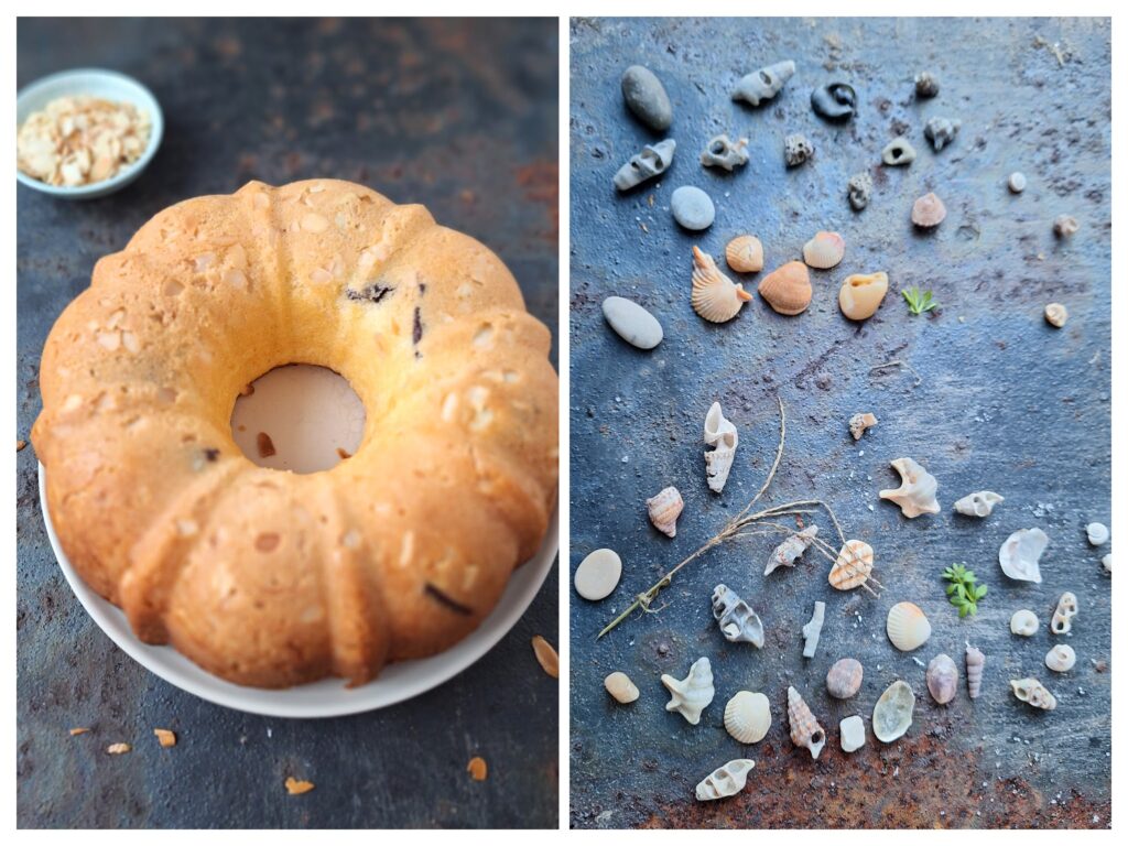 Ganzer Napfkuchen mit Mandelblättchen und Schokostücken  auf dem Teller und viele kleine Muscheln.