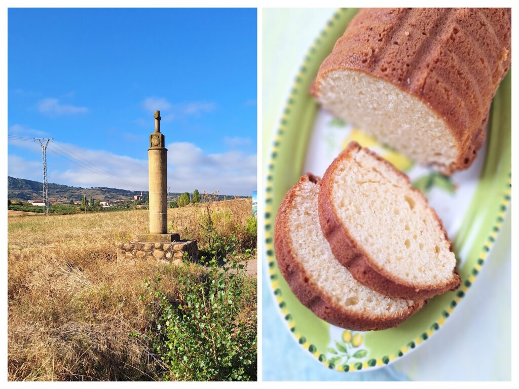 Eine Säule mit Kreuz auf Camino Frances und angeschnittener Zitronenkuchen.